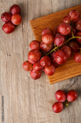 Red grapes on wooden table