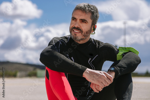 Young adult man resiting in the floor after run photo