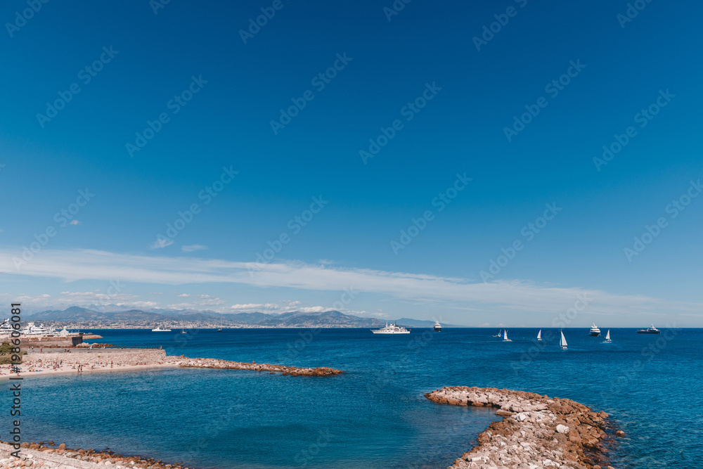 ships floating in sea on sunny day, Antibes, France