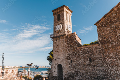 Ancient church with clock tower at old European city, Cannes, France