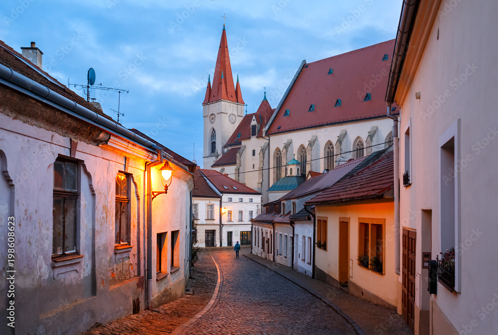 Old charming paved street with night illumination in the historical centre leading to the ancient St. Nicholas Church. Town of Znojmo, Czech Republic, South Moravia, Europe Old charming paved street with night illumination in the historical centre leading to the ancient St. Nicholas Church. Town of Znojmo, Czech Republic, South Moravia, Europe