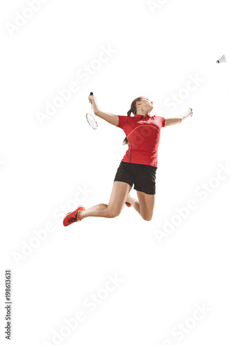 Young woman playing badminton over white background