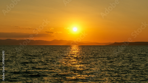 Beautiful sunset at sea, against islands