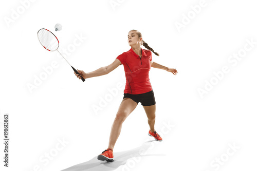 Young woman playing badminton over white background