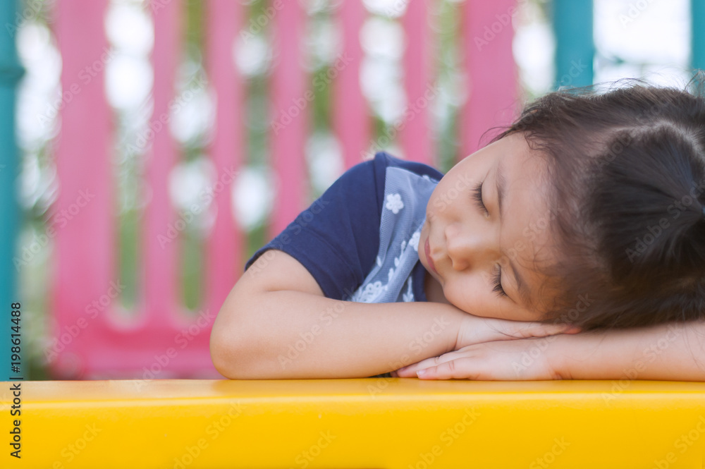 Cute a Little Asian Girl sleeping in the Playground. Cute a Little Asian Girl sleeping in the Playground.
