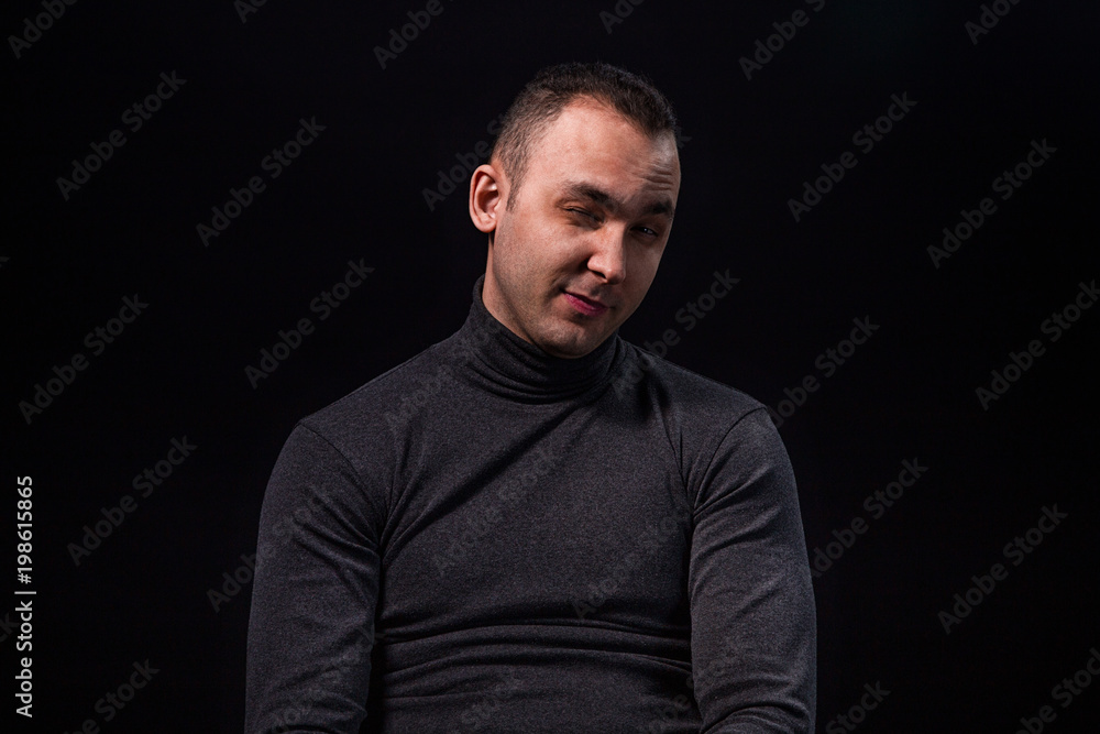 Sceptical sitting young man