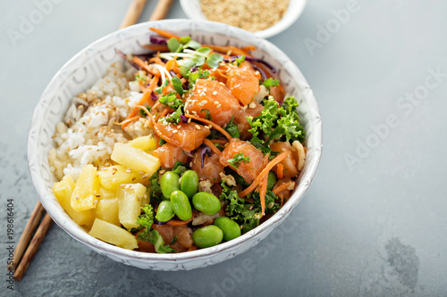 Poke bowl with raw salmon, rice and vegetables