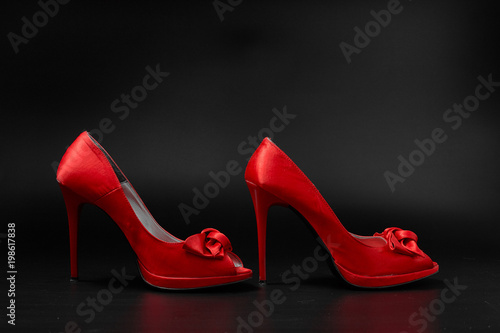 red fashion women shoes on a black background.