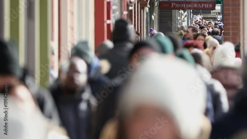 People walking down crowed sidewalk during Sundance Film Festival in Park City Utah. photo