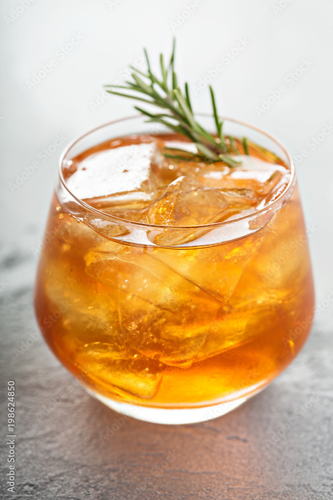 Old fashioned cocktail with ice and rosemary Old fashioned cocktail with ice and rosemary