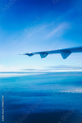 Wallpaper Mural Airplane wings in the sky and clouds, Classic image through aircraft window onto jet engine Torontodigital.ca