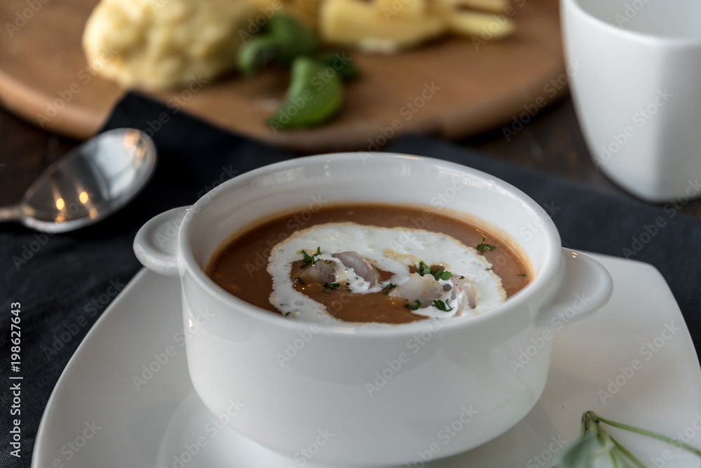 Vegetable cream soup with shrimps in bowl on table Vegetable cream soup with shrimps in bowl on table