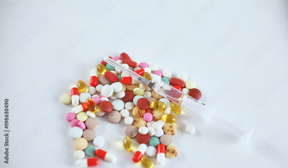 Medical pills and a bottle lie on the table. Medical concept Medical pills and a bottle lie on the table. Medical concept