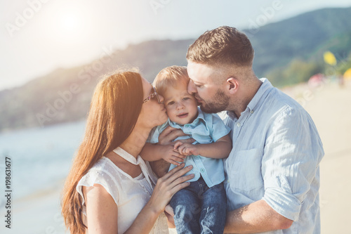 Father, Mother and Kid with relax activity, walking and playing on the tropical beach