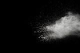 White powder explosion on black background.Stopping the movement of white powder on dark background. Launched white powder splash.