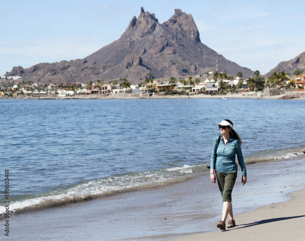 A Woman Walks the Beach, Tetakawi Mountain Behind, San Carlos, Mexico A Woman Walks the Beach, Tetakawi Mountain Behind, San Carlos, Mexico