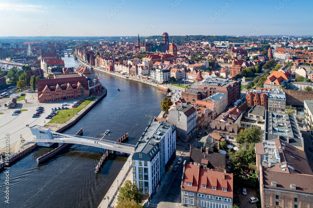Gdansk, Poland. Aerial skyline panorama with Motlawa river, 4 bridges, Baltic Philharmonic Hall and famous monuments: medieval crane, St Mary, St John churches, city hall tower and old houses