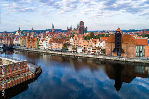 Gdansk old city in Poland with the oldest medieval port crane (Zuraw) in Europe, St Mary church, Town hall tower and Motlawa River. Aerial view, early morning