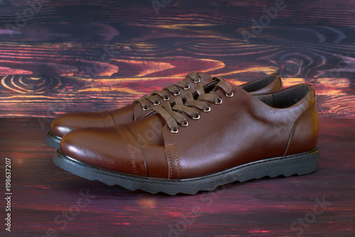 brown boots on dark wooden background