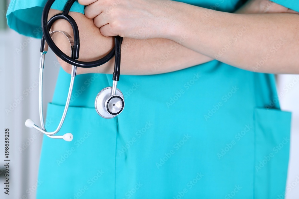 Unknown female doctor holds stethoscope closeup. Physician ready to examine and help patient. Medical help and insurance in health care, best treatment and medicine concept Unknown female doctor holds stethoscope closeup. Physician ready to examine and help patient. Medical help and insurance in health care, best treatment and medicine concept