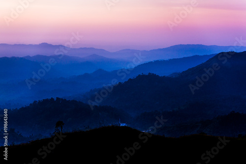layer mountains in the evening in the tropical rainforest of Thailand photo