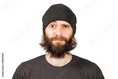 Young bearded man in hat winking. Isolated on white.