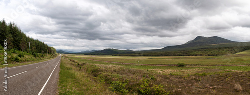 Typical mountainous landscape with a road in Scotland.