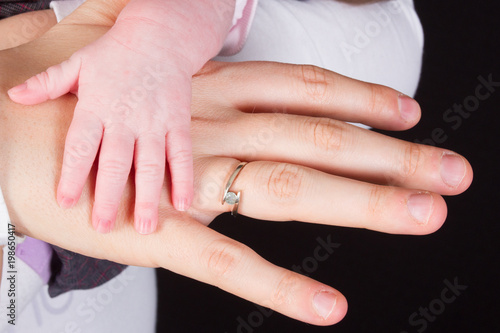close up detail of mother and baby newborn hands