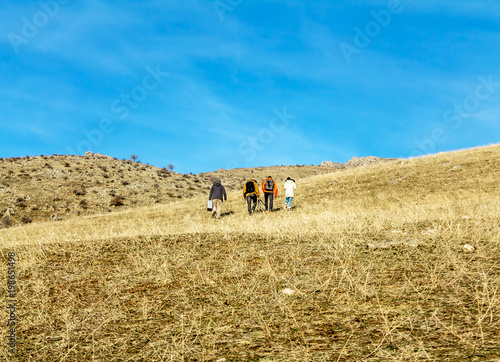 Tourists in the mountains landscape photo