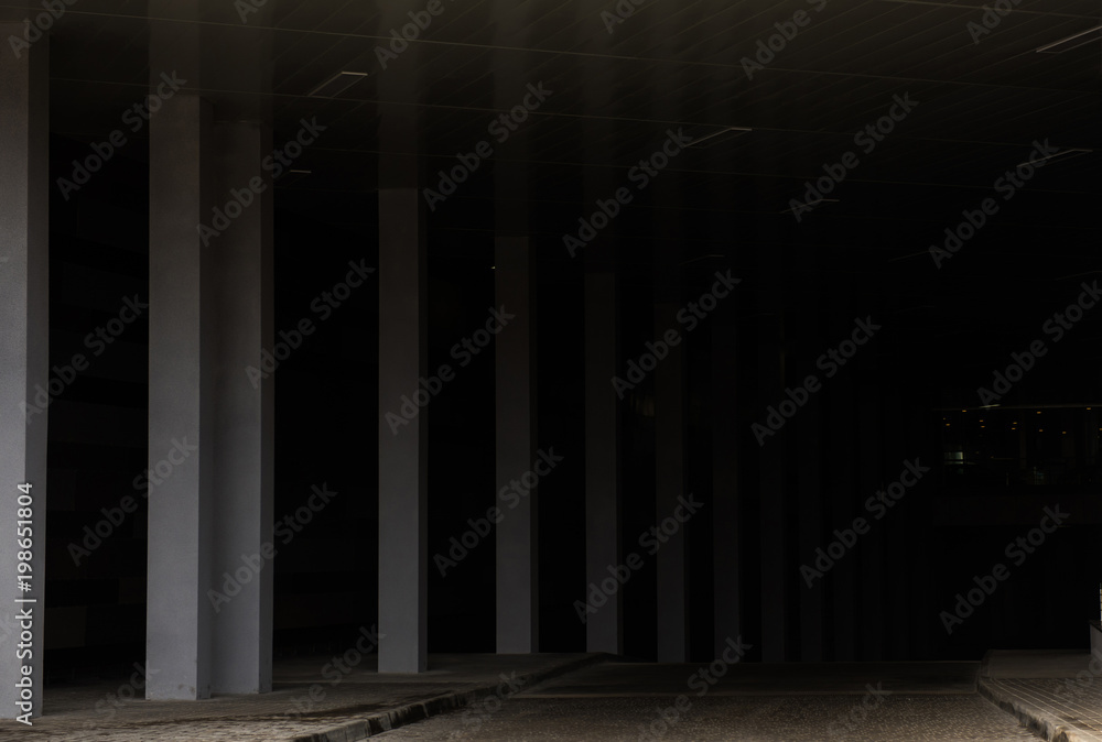 Cement pillars, surround a dark grey background Cement pillars, surround a dark grey background