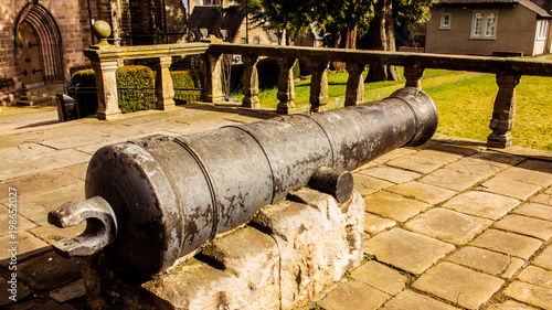 Black iron cannon beside Cowane’s Hospital and Holy Rude Church in the historic town of Stirling. photo