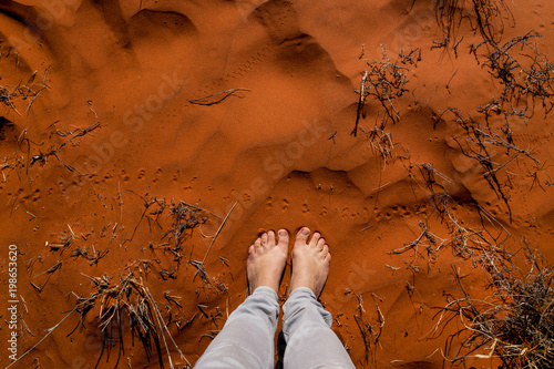 Woman feet in the red australian sand. Nothern Territory, Australia.