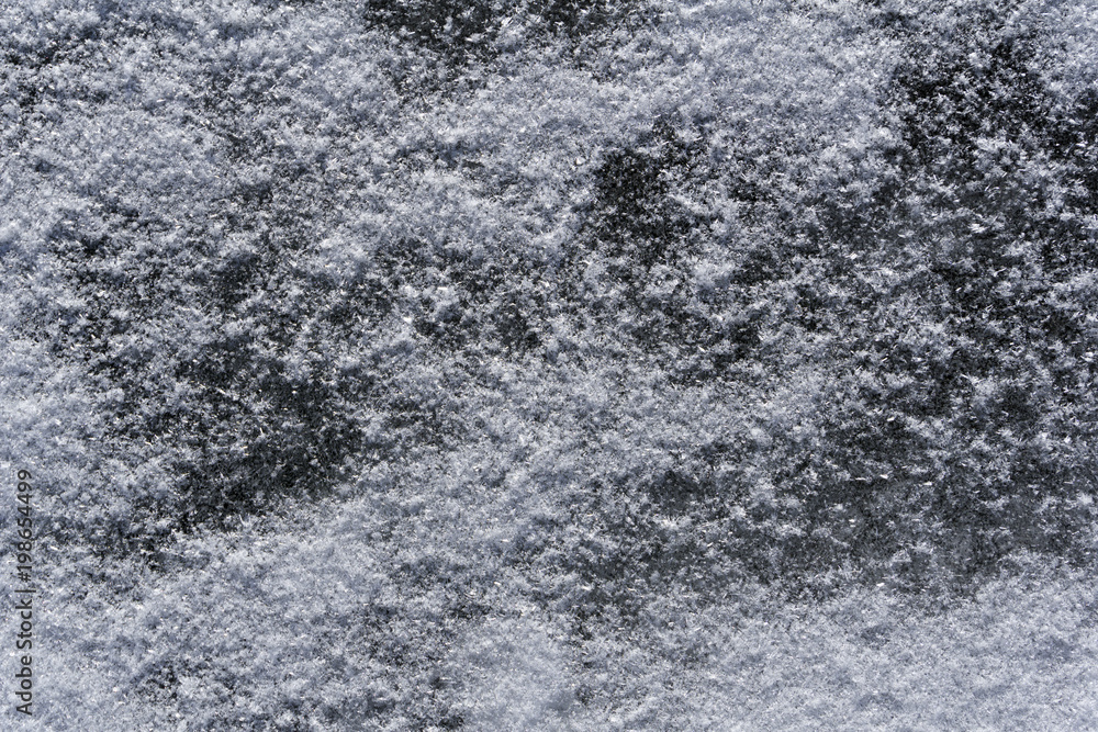 background, texture - small snow crystals on a dark river ice closeup background, texture - small snow crystals on a dark river ice closeup