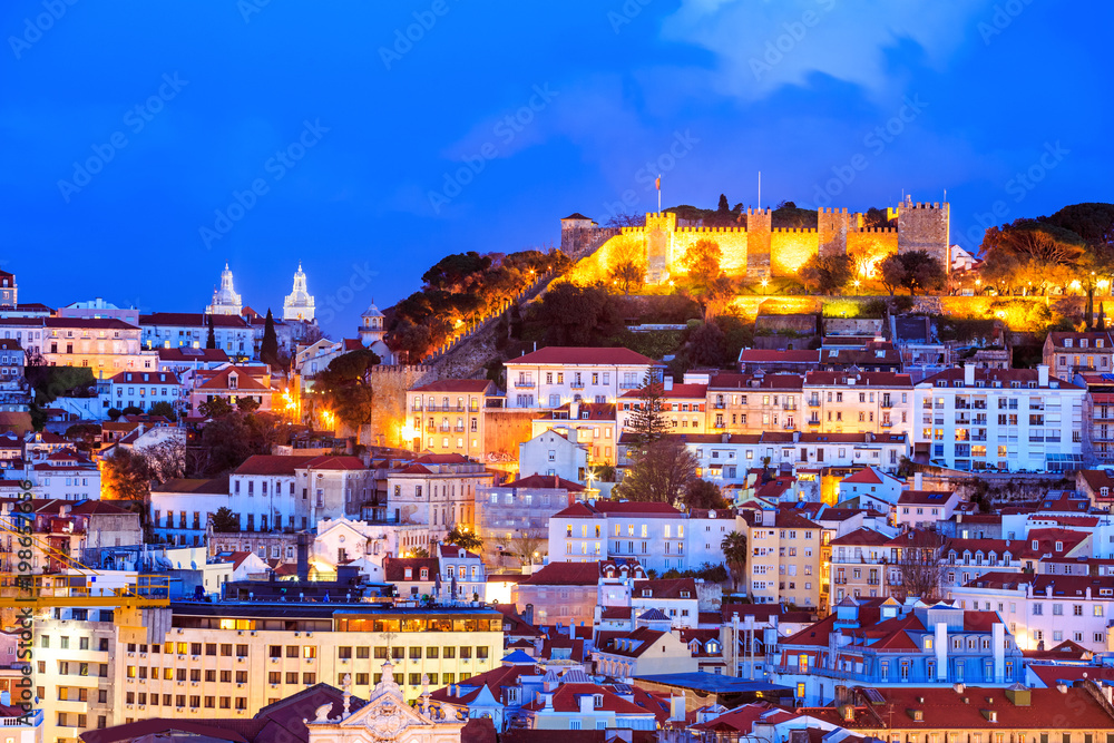 Panoramic view with traditional architecture of Lisbon illuminated in evening lights in Portugal