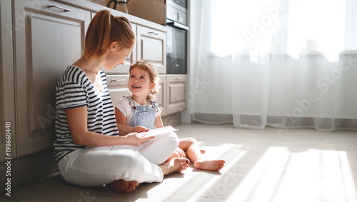happy mother's day! child daughter congratulates her mother and  read postcard
