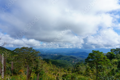 panorama landscape of field with sky and cloud and layer of mountain background