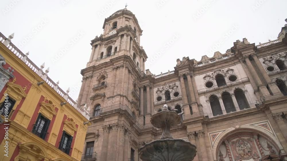 Fountain and the Malaga Cathedral's tower Fountain and the Malaga Cathedral's tower