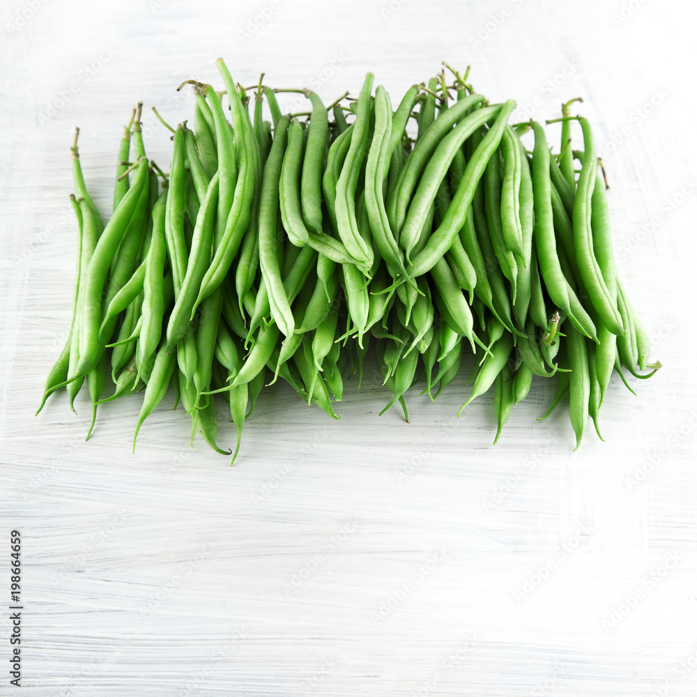 fresh green beans on white wooden kitchen plate, shabby chic, can be used as background fresh green beans on white wooden kitchen plate, shabby chic, can be used as background