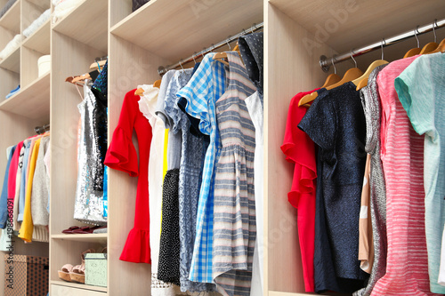 Large wardrobe with female clothes in dressing room