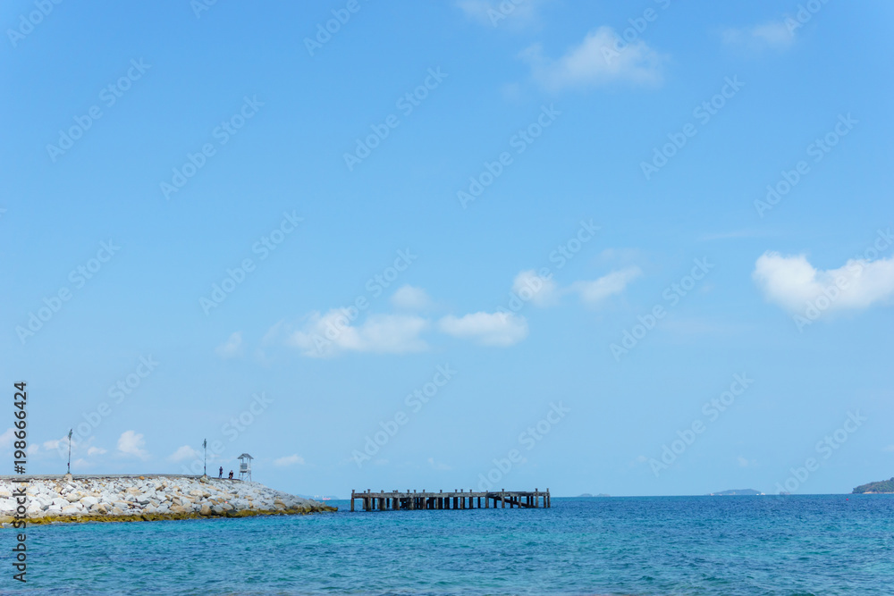 landscape panorama view of ocean blue sea with blue sky and little cloud and rock peir in the sea.