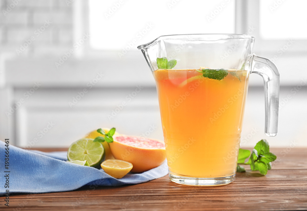 Fototapeta premium Tasty lemonade with mint in jug on table