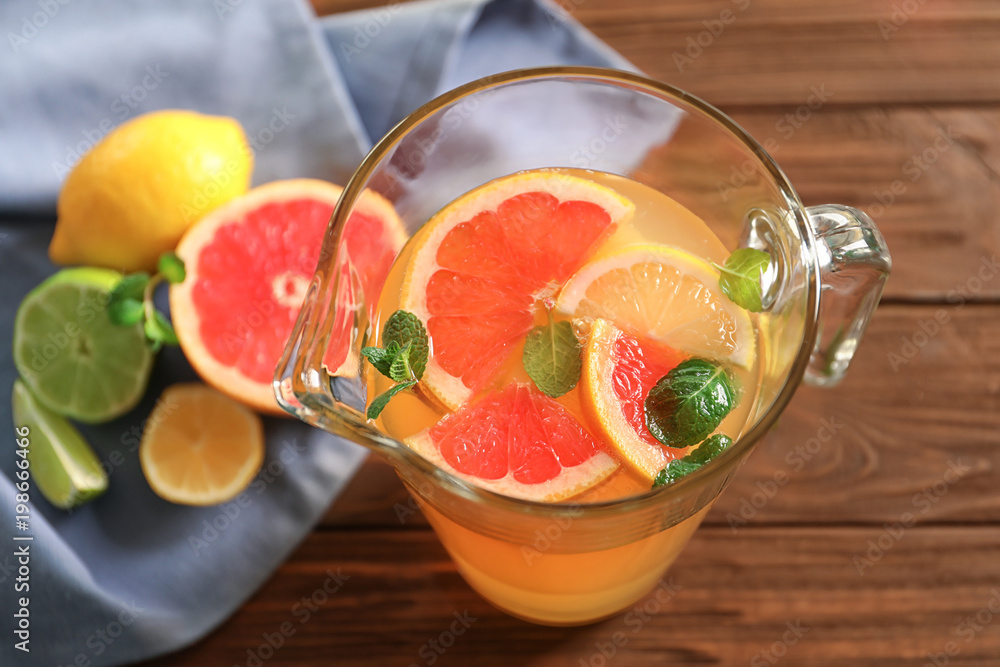 Tasty lemonade with citrus fruits in pitcher on table Tasty lemonade with citrus fruits in pitcher on table