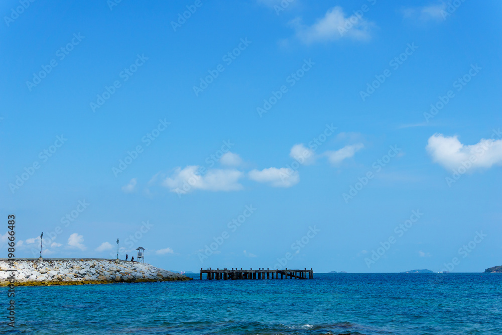 landscape panorama view of ocean blue sea with blue sky and little cloud and rock peir in the sea.
