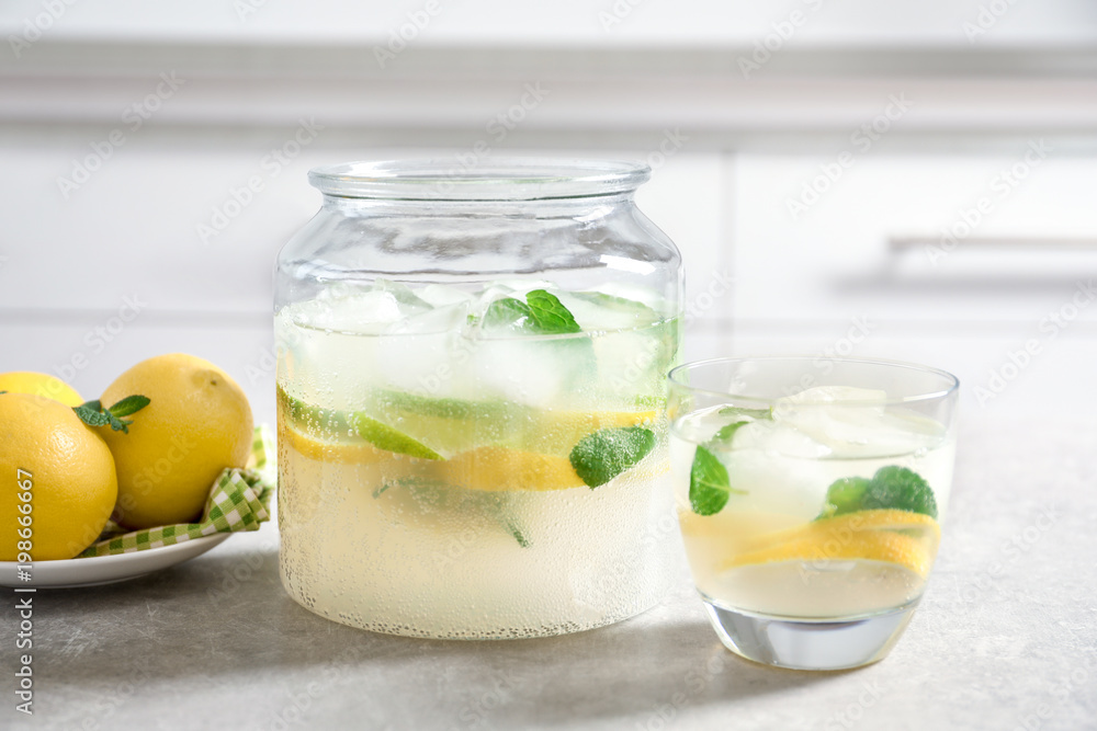Jar and glass of fresh lemonade on table Jar and glass of fresh lemonade on table