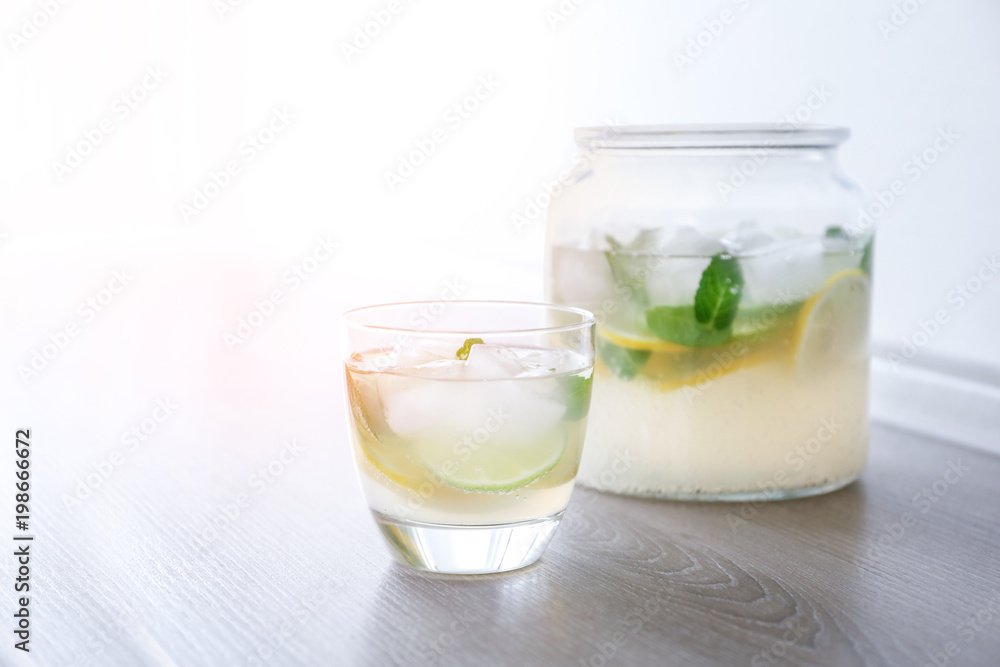 Jar and glass of fresh lemonade on table Jar and glass of fresh lemonade on table