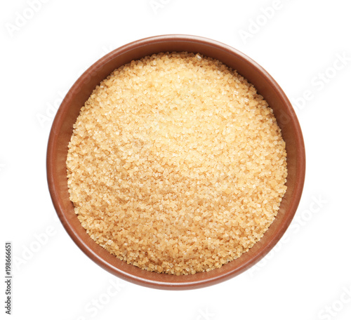 Bowl with brown sugar on white background