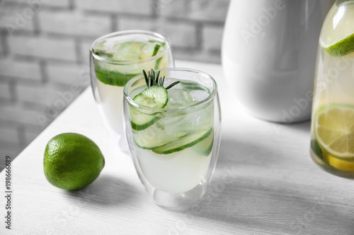 Glasses of fresh lemonade on table