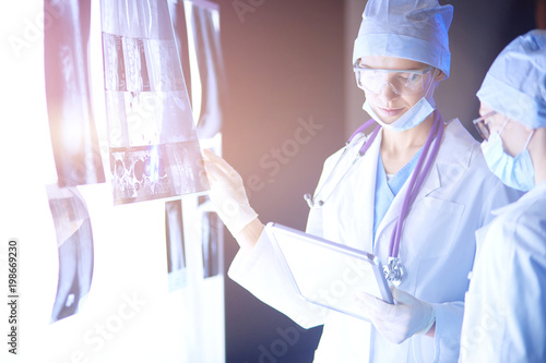 Two female women medical doctors looking at x-rays in a hospital