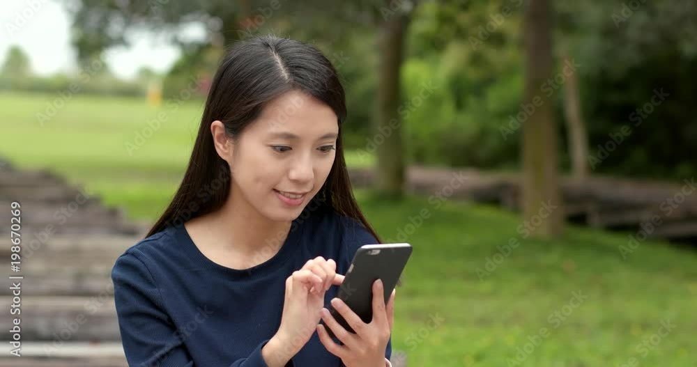 Young woman use of mobile phone in countryside Young woman use of mobile phone in countryside