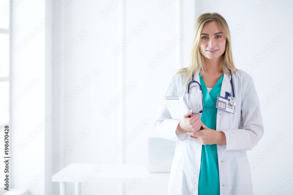Portrait of three confident female doctors standing with arms crossed at the medical office Portrait of three confident female doctors standing with arms crossed at the medical office